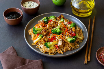 Udon noodles with tofu, broccoli, carrots, pepper and sesame. Healthy eating. Vegetarian food. Asian food.