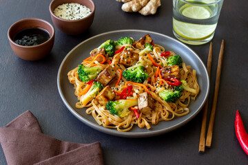 Udon noodles with tofu, broccoli, carrots, pepper and sesame. Healthy eating. Vegetarian food. Asian food.