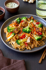 Udon noodles with tofu, broccoli, carrots, pepper and sesame. Healthy eating. Vegetarian food. Asian food.