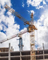 Fototapeta na wymiar Crane at a construction site against the sky