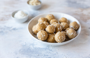 Chickpea and peanut butter candies with coconut chips. Energy balls. Healthy raw dessert without sugar. Vegan truffles.