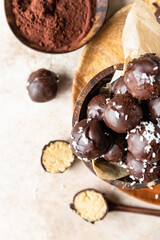 Vegan chickpea and peanut butter candies in chocolate glaze with coconut chips. Energy balls. Healthy raw dessert without sugar.