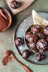 Vegan chickpea and peanut butter candies in chocolate glaze with coconut chips. Energy balls. Healthy raw dessert without sugar.
