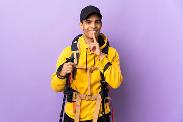 African American man with backpack and trekking poles over isolated background showing a sign of silence gesture putting finger in mouth