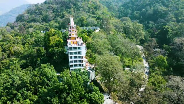 isolate multistory hindu temple in the middle of the forests from different angle aerial shot