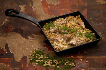 Lentil soup with greens, meat and white sauce