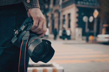 the photographer holds the camera in his hand