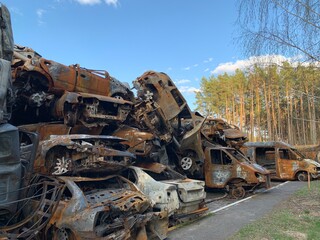 Fototapeta premium Burnt and blown up car. Traces of shots on the body of the car. Cars damaged after shelling. War between Russia and Ukraine, Irpin-Bucha, April 10, 2022