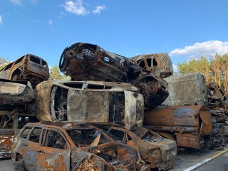 Fototapeta premium Burnt and blown up car. Traces of shots on the body of the car. Cars damaged after shelling. War between Russia and Ukraine, Irpin-Bucha, April 10, 2022