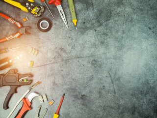 set of tools of a professional electrician on a concrete background with space for text
