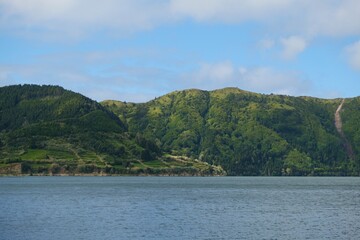 Green mountains, lake and the blue sky