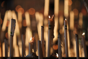 close up of candles in a church