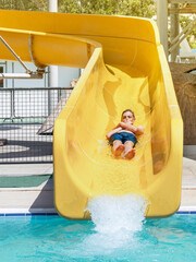 teenager slides down the water slide at the water park
