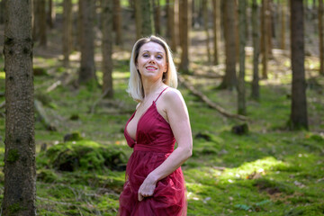 Smiling beautiful sexy woman wearing magenta dress.