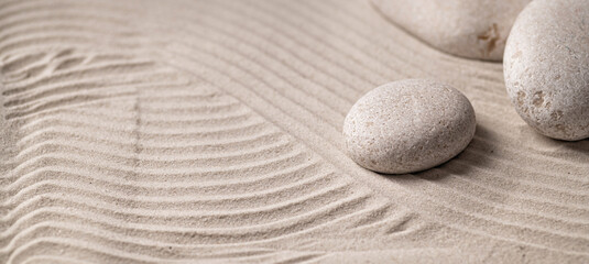 Fototapeta na wymiar Round stones on the sand, zen, relaxation, texture, background, place for text