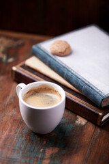 Cup of coffee on rustic wooden background.
