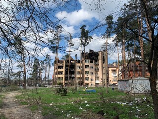 Fototapeta na wymiar The ruins of multi-storey buildings after the shelling. The house was damaged by bombs and aircraft. Burnt houses due to explosions. War between Russia and Ukraine, Irpin-Bucha, April 10, 2022
