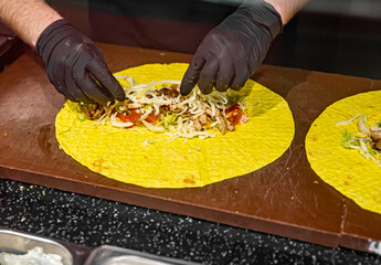 process of preparing traditional Turkish fast food - shawarma or kebab. chef hand cooking food