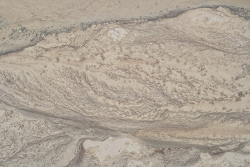 Wet limestone surface with traces of water flows.
