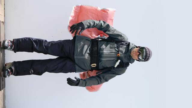 Avalanche airbag deployment on imperfect white background - 4K shot at 50fps - slight slowmotion - modified color