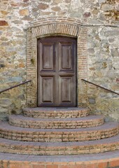 Wooden door in a traditional stone facade in the Extremadura - Spain 