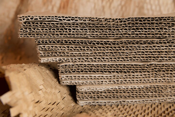 Sheets of corrugated cardboard lie on top of each other on kraft paper, printing production....