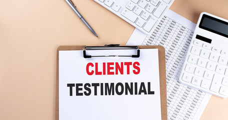 clipboard with white blank paper text Clients Testimonial , keyboard calculator and chart, top...