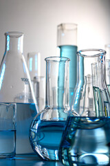 Close up of labware such as beaker, flask, graduated cylinders and test tubes well placed