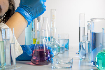 Hand of a scientist taking samples with a pipette