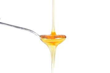 Image of honey on a spoon on a white background