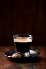  Coffee in glass cup on dark wooden background. Copy space. 