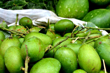 Green mangoes in a village market in India