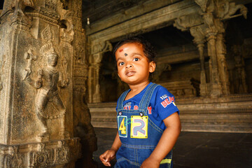 A cute little Indian child in a Hindu temple