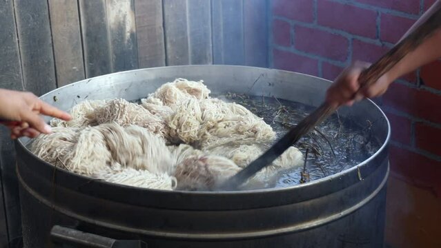 Dying a Batch of yarn in a Large Pot with Dried Plants