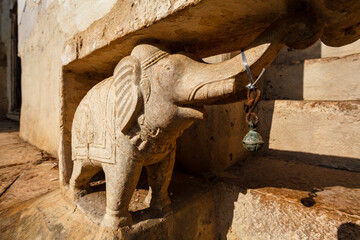 Close up of an elephant sculpture with a bell on the wall of the royal palace in Bundi, Rajasthan, India, Asia