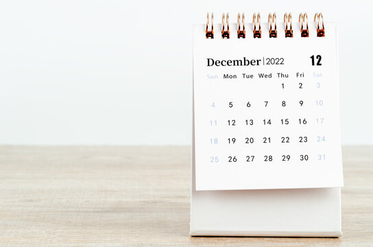 December 2022 Desk Calendar On Wooden Background.