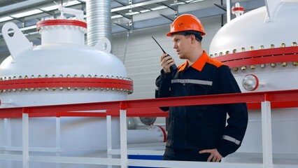 A worker in the oil and gas industry oversees the purification and compression of gas at an oil...