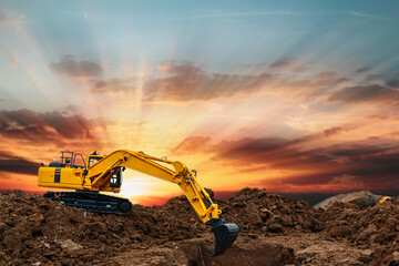 Excavators  are digging soil with  in the construction site on sunbeam  background © chaphot