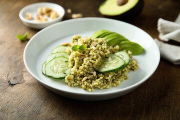 Couscous with pesto, cucumber and avocado