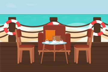 terrace of the restaurant with chairs and tables on a sandy beach near the sea