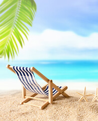 Vacation holidays background concept - beach lounge chair under palm on summer beach.