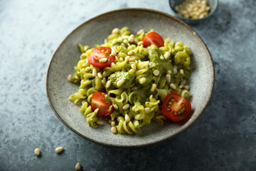 Pasta with pesto sauce and tomatoes