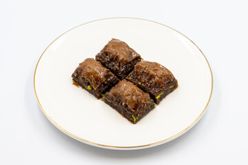 Chocolate baklava. Chocolate baklava with pistachio isolated on white background. Mediterranean cuisine delicacies. Close-up. local name cikolatali baklava