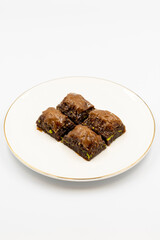 Chocolate baklava. Chocolate baklava with pistachio isolated on white background. Mediterranean cuisine delicacies. Close-up. local name cikolatali baklava