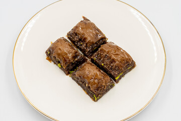 Chocolate baklava. Chocolate baklava with pistachio isolated on white background. Mediterranean cuisine delicacies. Close-up. local name cikolatali baklava