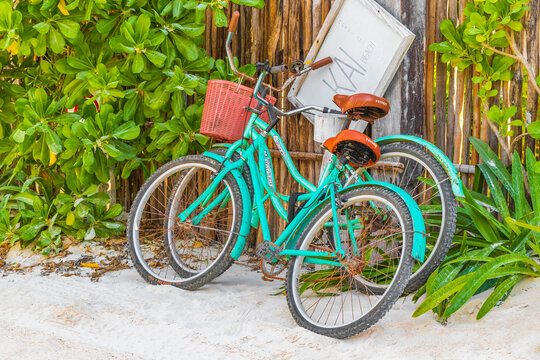Turquoise bikes bicycles at caribbean coast and beach Tulum Mexico.