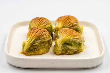 Mussel baklava. Pistachio baklava isolated on a white background. Mediterranean cuisine delicacies. Close-up. local name midye baklava