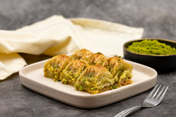 Pistachio baklava. Baklava with pistachio on a dark background. Mediterranean cuisine delicacies. Close-up. local name cimcik baklava
