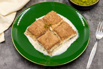 Cold baklava. Baklava with milk on a dark background. Mediterranean cuisine delicacies. Close-up. Local name soguk baklava