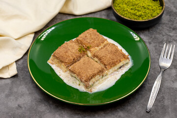 Cold baklava. Baklava with milk on a dark background. Mediterranean cuisine delicacies. Close-up. Local name soguk baklava